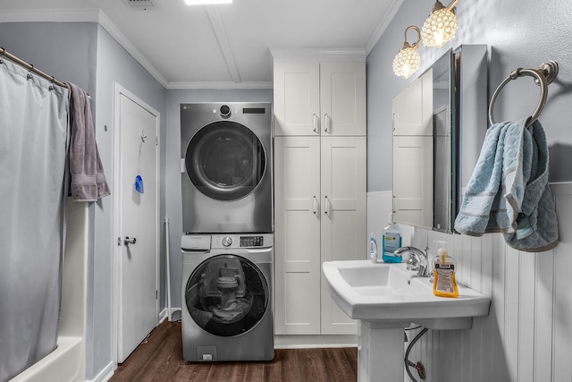 6440 Harmonson Rd, North Richland Hills, TX 76180 - washroom featuring stacked washer / dryer, dark wood finished floors, and crown molding