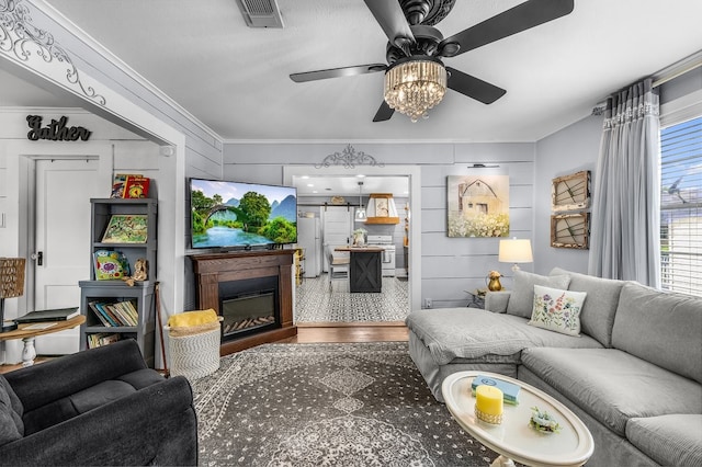6440 Harmonson Rd, North Richland Hills, TX 76180 - living area with a ceiling fan, crown molding, a glass covered fireplace, and wood finished floors