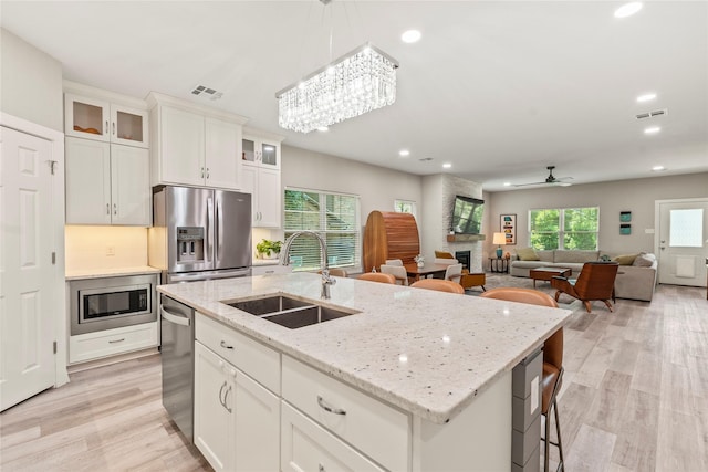 103 Idlewood Rd, Enchanted Oaks, TX 75156 - kitchen with a sink, appliances with stainless steel finishes, light wood-type flooring, recessed lighting, and ceiling fan