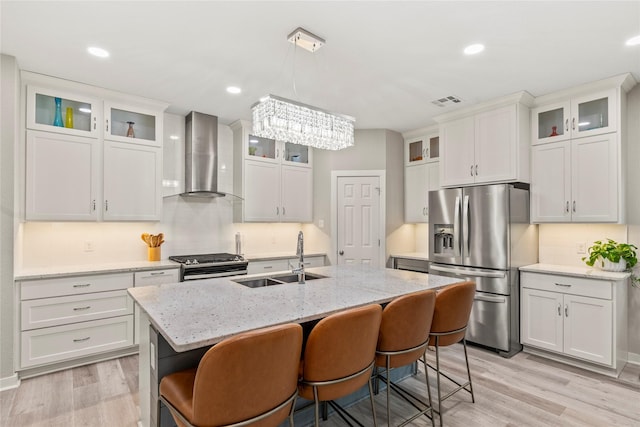 103 Idlewood Rd, Enchanted Oaks, TX 75156 - kitchen with stainless steel appliances, a sink, wall chimney range hood, light wood-type flooring, and recessed lighting