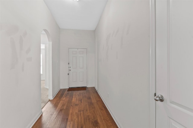 2118 Cone Flower Dr, Forney, TX 75126 - doorway featuring arched walkways, dark wood-type flooring, and baseboards