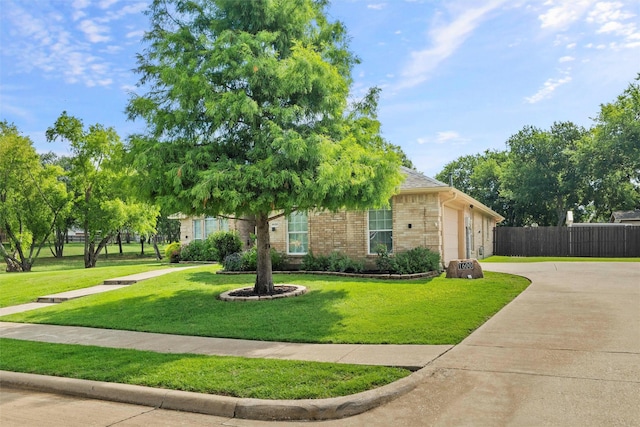 1600 Country Walk Ln, Wylie, TX 75098 - obstructed view of property featuring concrete driveway, an attached garage, and brick siding
