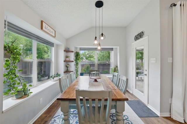1600 Country Walk Ln, Wylie, TX 75098 - dining area with wood finished floors, a textured ceiling, vaulted ceiling, and baseboards