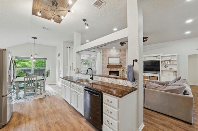 1600 Country Walk Ln, Wylie, TX 75098 - kitchen featuring black dishwasher, stainless steel fridge with ice dispenser, open floor plan, a sink, and a textured ceiling