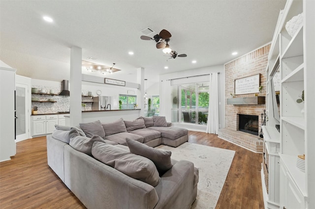1600 Country Walk Ln, Wylie, TX 75098 - living room with ceiling fan, a fireplace, wood finished floors, and recessed lighting