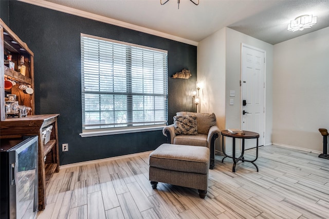 816 Hartsfield St, Aubrey, TX 76227 - sitting room with wine cooler, wood finished floors, and baseboards