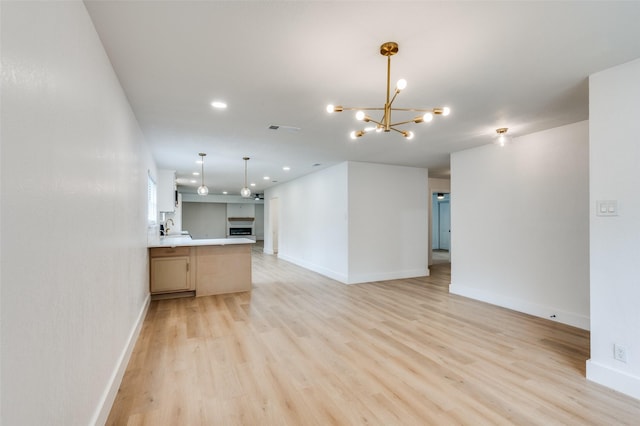 611 Cannon Dr, Euless, TX 76040 - unfurnished living room featuring light wood finished floors, a chandelier, baseboards, recessed lighting, and a sink