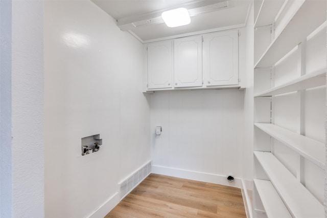 611 Cannon Dr, Euless, TX 76040 - laundry area featuring washer hookup, baseboards, cabinet space, and light wood finished floors