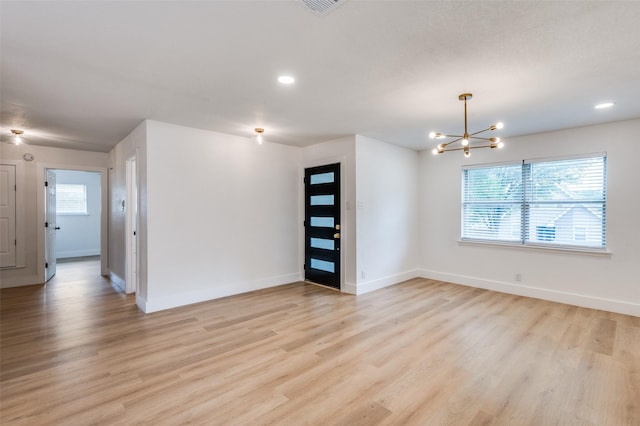 611 Cannon Dr, Euless, TX 76040 - empty room featuring healthy amount of natural light, a chandelier, baseboards, light wood-style floors, and recessed lighting