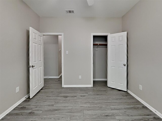 529 Covey Trl, Rockwall, TX 75087 - unfurnished bedroom featuring wood finished floors, a closet, and baseboards