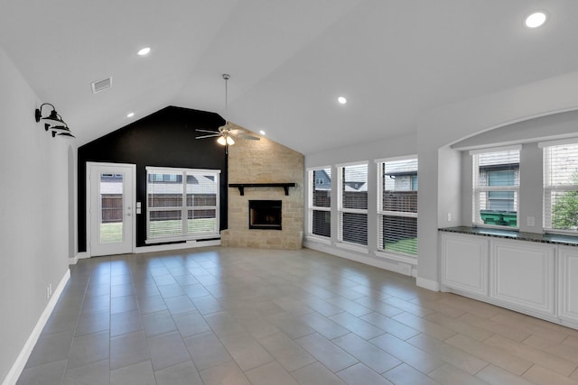 2111 Devonblue Dr, Forney, TX 75126 - unfurnished living room featuring ceiling fan, vaulted ceiling, a stone fireplace, recessed lighting, and baseboards