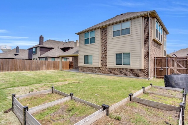 2111 Devonblue Dr, Forney, TX 75126 - rear view of house featuring a vegetable garden and brick siding