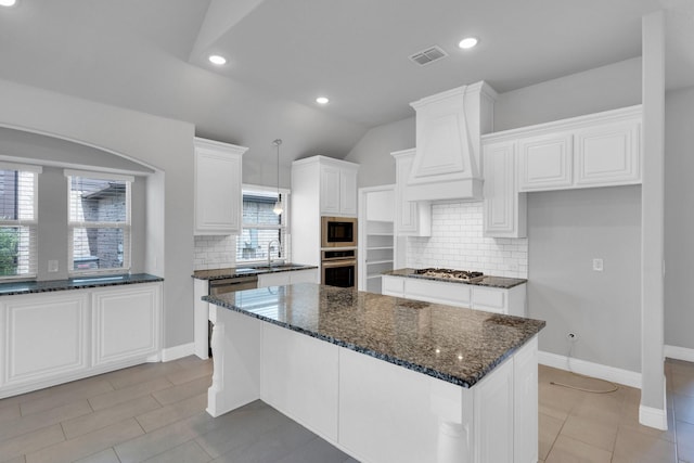 2111 Devonblue Dr, Forney, TX 75126 - kitchen with stainless steel appliances, tasteful backsplash, dark stone countertops, white cabinetry, and recessed lighting