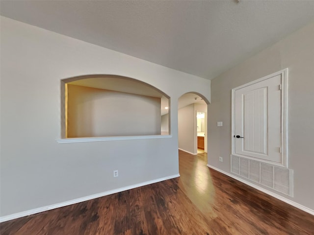 11721 Summer Springs Dr, Frisco, TX 75036 - unfurnished room with wood finished floors, baseboards, and arched walkways