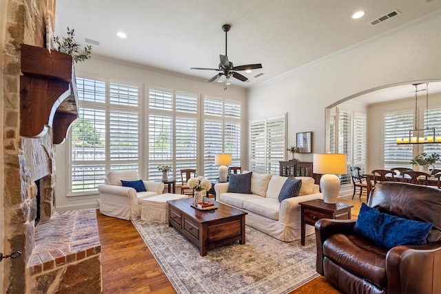 1632 Coyote Rdg, Carrollton, TX 75010 - living room featuring ceiling fan, arched walkways, healthy amount of natural light, crown molding, and recessed lighting