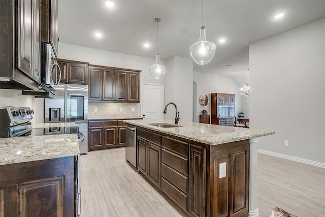 812 Porcupine Dr, Springtown, TX 76082 - kitchen with appliances with stainless steel finishes, a sink, tasteful backsplash, dark brown cabinets, and recessed lighting