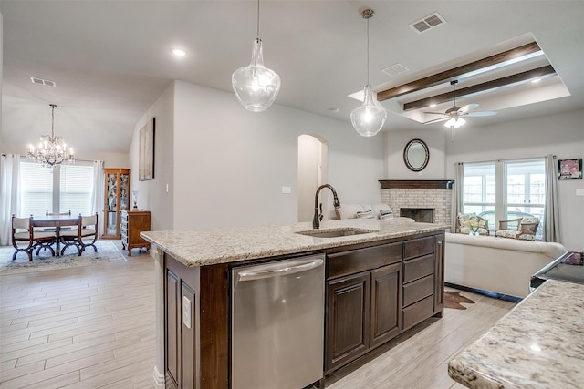 812 Porcupine Dr, Springtown, TX 76082 - kitchen featuring dishwasher, a sink, a ceiling fan, light wood-style flooring, and arched walkways