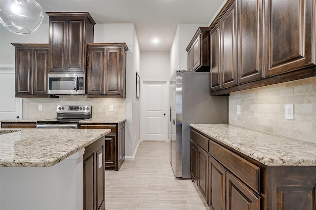 812 Porcupine Dr, Springtown, TX 76082 - kitchen featuring appliances with stainless steel finishes, dark brown cabinets, backsplash, and recessed lighting
