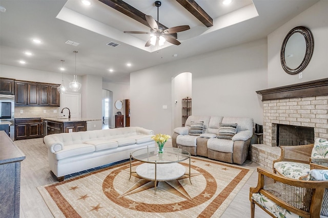 812 Porcupine Dr, Springtown, TX 76082 - living room with a ceiling fan, arched walkways, recessed lighting, light wood-style floors, and a fireplace