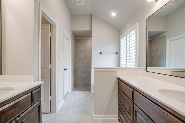 812 Porcupine Dr, Springtown, TX 76082 - full bathroom featuring two vanities, a walk in shower, vaulted ceiling, and recessed lighting