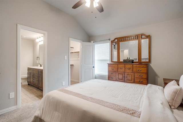 812 Porcupine Dr, Springtown, TX 76082 - bedroom with vaulted ceiling, a sink, baseboards, ensuite bathroom, and a spacious closet