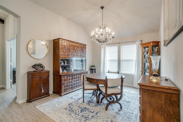 812 Porcupine Dr, Springtown, TX 76082 - dining area featuring light wood-style floors, baseboards, a chandelier, lofted ceiling, and arched walkways