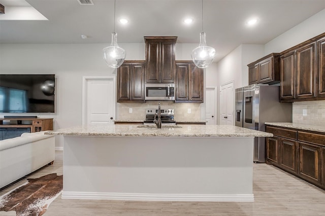 812 Porcupine Dr, Springtown, TX 76082 - kitchen with stainless steel appliances, tasteful backsplash, light stone counters, dark brown cabinets, and recessed lighting