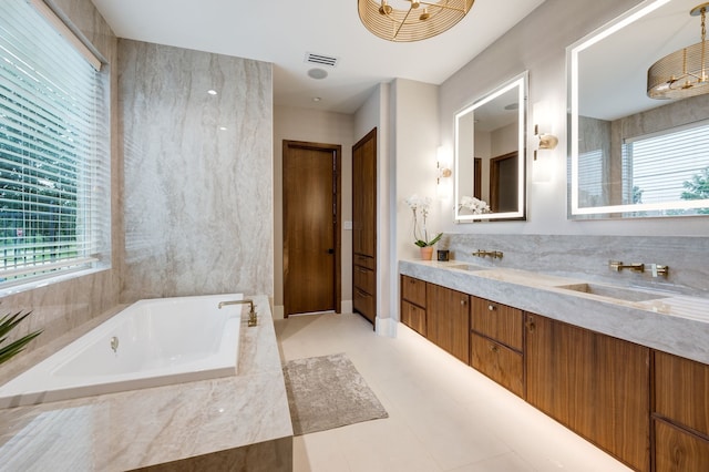 912 Berkshire Rd, Southlake, TX 76092 - full bath featuring healthy amount of natural light, a tub with jets, double vanity, and tile patterned floors
