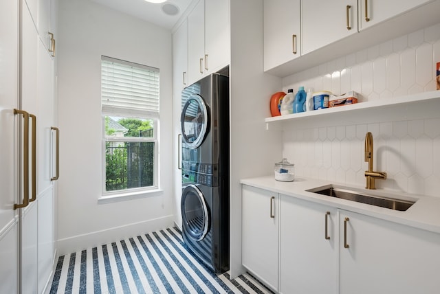912 Berkshire Rd, Southlake, TX 76092 - laundry area featuring stacked washer / dryer, cabinet space, baseboards, and carpet