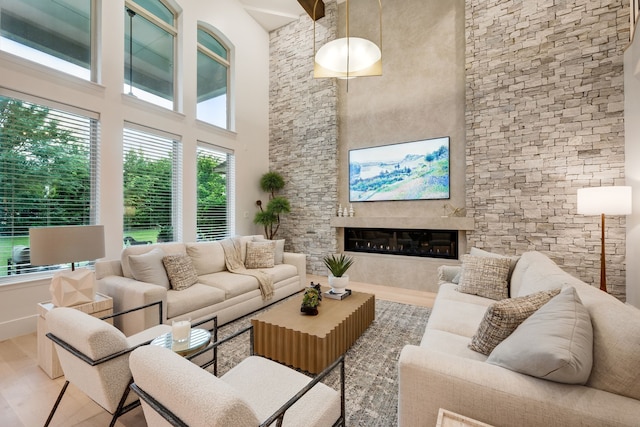 912 Berkshire Rd, Southlake, TX 76092 - living room featuring a towering ceiling, wood finished floors, and a glass covered fireplace