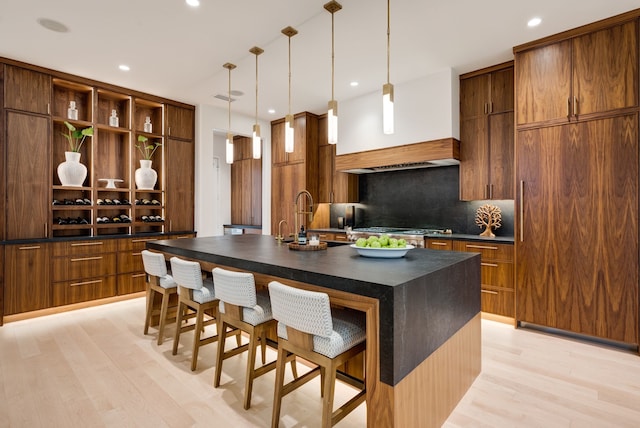 912 Berkshire Rd, Southlake, TX 76092 - kitchen featuring dark countertops, tasteful backsplash, a kitchen breakfast bar, light wood finished floors, and open shelves