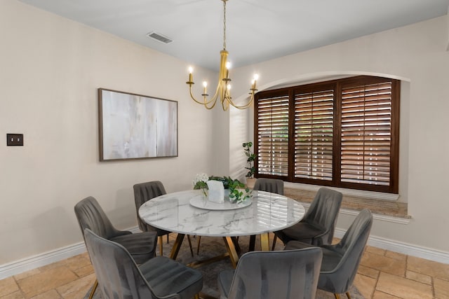 9 Haywood Ct, Frisco, TX 75035 - dining room with stone tile floors and a chandelier
