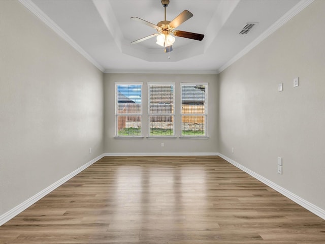 14824 Angel Trace Dr, Aledo, TX 76008 - unfurnished room with a tray ceiling, light wood-type flooring, a ceiling fan, baseboards, and crown molding