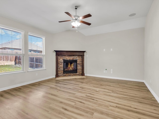 14824 Angel Trace Dr, Aledo, TX 76008 - unfurnished living room featuring ceiling fan, light wood finished floors, baseboards, a stone fireplace, and lofted ceiling