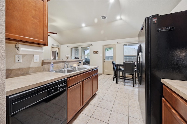 10149 High Eagle Trl, Fort Worth, TX 76108 - kitchen with black appliances, vaulted ceiling, a sink, brown cabinets, and light countertops
