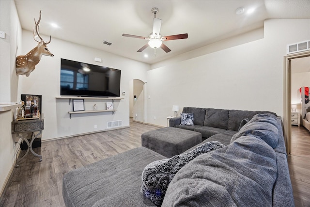 10149 High Eagle Trl, Fort Worth, TX 76108 - living room featuring a ceiling fan, arched walkways, wood finished floors, vaulted ceiling, and baseboards