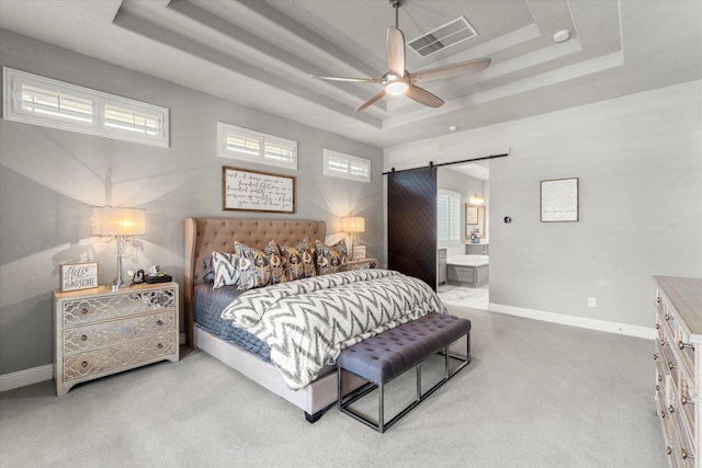 1741 Mountain Creek Ln, Prosper, TX 75078 - bedroom featuring a tray ceiling, a barn door, light colored carpet, and baseboards