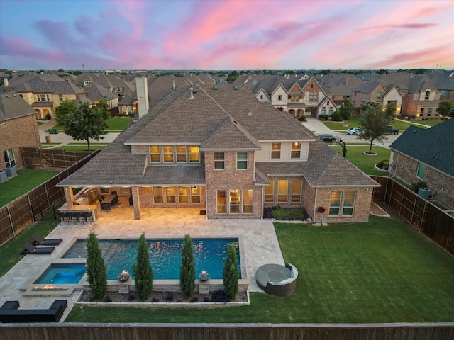 1741 Mountain Creek Ln, Prosper, TX 75078 - back of property at dusk featuring brick siding, a shingled roof, a chimney, and a residential view