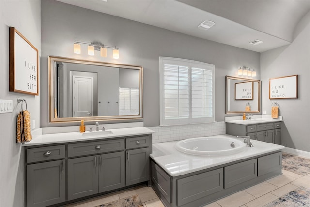 1741 Mountain Creek Ln, Prosper, TX 75078 - bathroom with two vanities, a bath, tile patterned floors, and baseboards