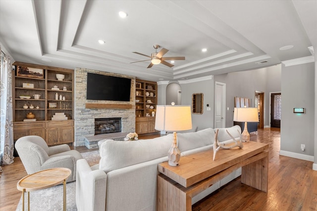 1741 Mountain Creek Ln, Prosper, TX 75078 - living room with a tray ceiling, baseboards, a ceiling fan, a fireplace, and wood finished floors