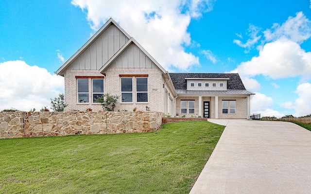7336 Saint Augustine Dr, Cleburne, TX 76033 - view of front of home with board and batten siding, a front yard, brick siding, and cooling unit