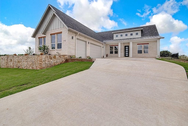 7336 Saint Augustine Dr, Cleburne, TX 76033 - view of front facade featuring an attached garage, driveway, a standing seam roof, and brick siding