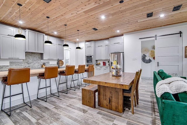 7336 Saint Augustine Dr, Cleburne, TX 76033 - kitchen with appliances with stainless steel finishes, wood ceiling, a barn door, light countertops, and recessed lighting