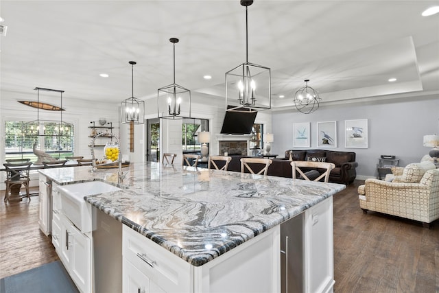 6575 Standing Rock, Malakoff, TX 75148 - kitchen featuring recessed lighting, dark wood-type flooring, an island with sink, open floor plan, and decorative light fixtures