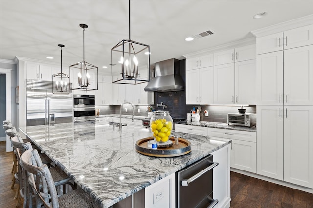 6575 Standing Rock, Malakoff, TX 75148 - kitchen featuring appliances with stainless steel finishes, wall chimney exhaust hood, a sink, white cabinetry, and recessed lighting