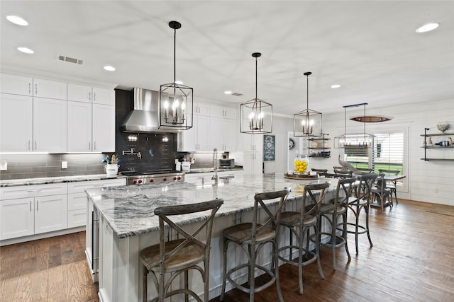 6575 Standing Rock, Malakoff, TX 75148 - kitchen with wall chimney range hood, tasteful backsplash, white cabinetry, a spacious island, and recessed lighting