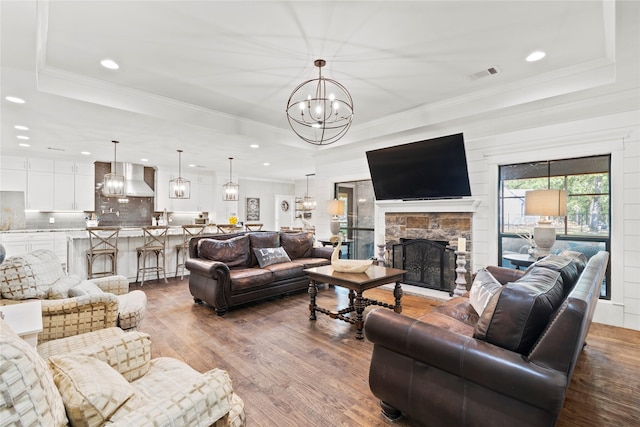 6575 Standing Rock, Malakoff, TX 75148 - living room with a raised ceiling, recessed lighting, a chandelier, dark wood-type flooring, and a fireplace