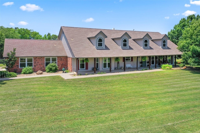 10595 Gregory Rd, Sanger, TX 76266 - cape cod home with a front yard, covered porch, roof with shingles, and brick siding