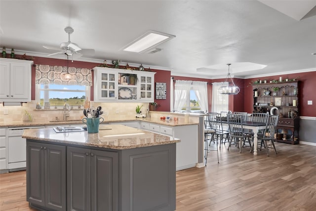 10595 Gregory Rd, Sanger, TX 76266 - kitchen with dishwasher, a peninsula, white cabinets, a center island, and light wood-style flooring
