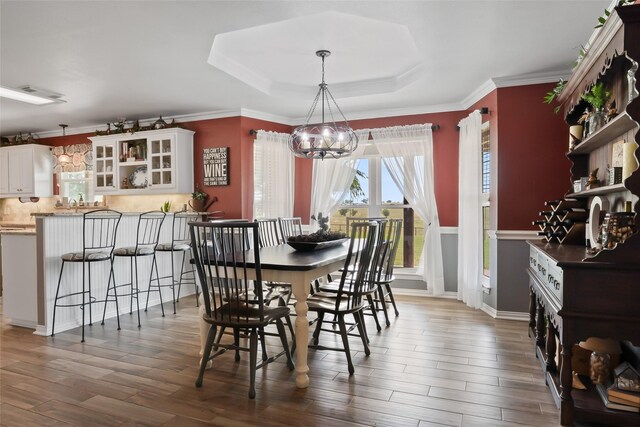 10595 Gregory Rd, Sanger, TX 76266 - dining room with a chandelier, wood finished floors, crown molding, and a tray ceiling